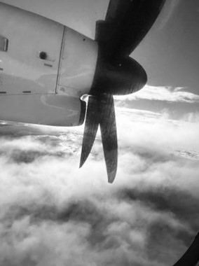 A plane propeller and clouds.